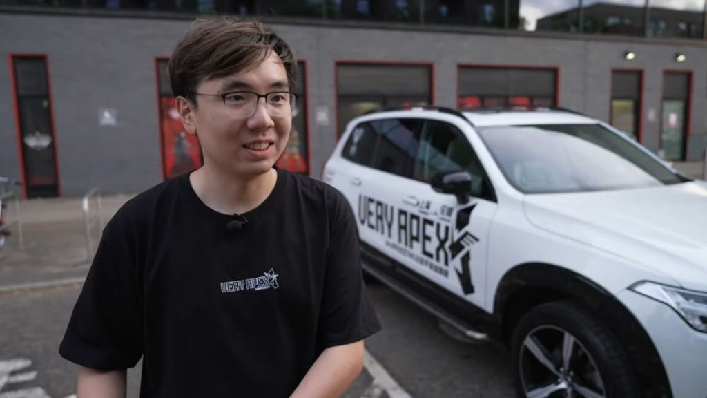 fan next to his apex legends car